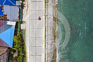 Top view of the Bohol circumferential highway hugging the coastline near the border of Valencia and Garcia Hernandez