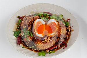 Top view boiled and fried duck eggs with tamarind sauce Garnish with dried chilies, fried shallots and coriander