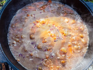 Top view of boiling pottage in iron cauldron