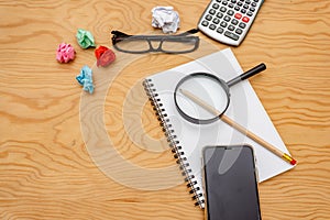 Top view book , calculator, glasses on wooden table