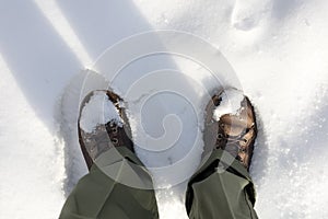 Top view of boots in white snow. Forest colours. Walking in the snow during winter in The Netherlands, Vlaardingen, Broekpolde