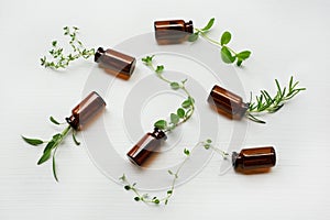 Top view, Bottle of essential oil with herbs sage, rosemary, or