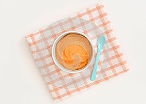 Top view bowl with carrot baby puree