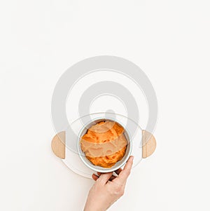 Top view bowl with carrot baby puree