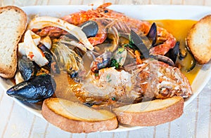 Top view of bowl with fish soup with seafood
