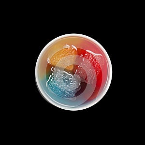 Top view of bowl with ice melting in primary colors on black photo