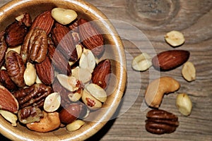 Top View of a Bowl of Mixed Nuts on a Wood Table