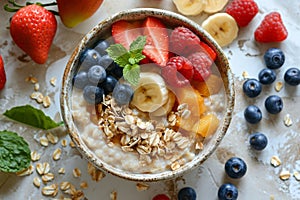 Top view of bowl with oatmeal porridge and fresh berries and fruits: strawberries, red currant, blueberries, raspberries