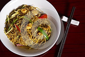 Top view of bowl of rice curry noodles. Typical oriental dish. Isolated image