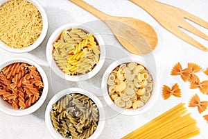 Top view of bowls with assorted uncooked pasta