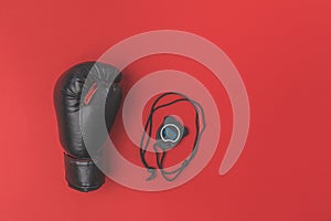 Boxing glove with stopwatch on red tabletop