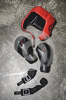 top view of boxing gloves and helmet with wrist wraps lying