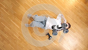 top view of a boy looking at a car model with a remote control, rc toy truck