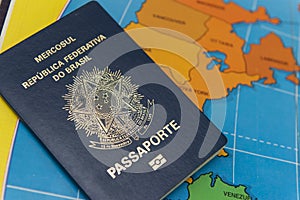 Top view of Brazilian passport over map.