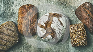 Top view of bread loaves over grey concrete background