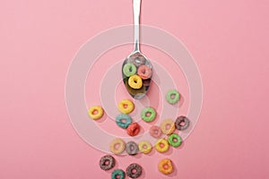 Top view of bright colorful breakfast cereal scattered from spoon