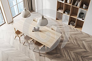 Top view on bright dining room interior with table, chairs