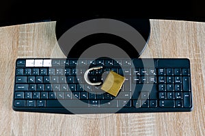 Top view of broken padlock on computer keyboard