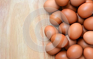 Top view of brown chicken eggs on wooden  background with copy space