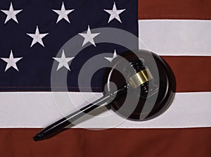 Top View of Brown Gavel Resting Sideways on American Flag with Stars and Stripes