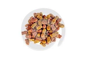 Top view of brown kibble pieces for cat feed heap isolated on white background. Healthy dry pet food.