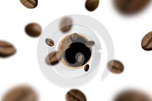 Top view of brown roasted coffee beans falling and flying to coffee cup on white background.