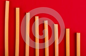 top view of bucatini pasta on red background