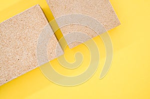 Top view of building thermal insulations made of ecologic materials isolated on yellow background