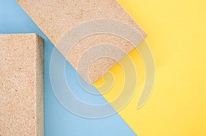 Top view of building thermal insulations made of ecologic materials on yellow and blue background