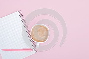 Top view business background workspace with coffee, pen and blank notebook on pink background. image for education, desktop, copy