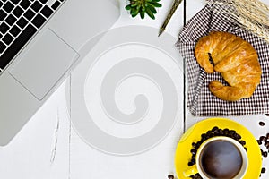 top view business breakfast with coffee and croussant. Rustic white wooden background with copy space