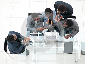 Top view. business colleagues shaking hands during office meeting.