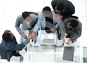 Top view. business colleagues shaking hands during office meeting.