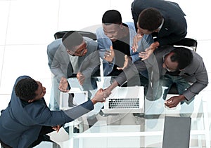 Top view. business colleagues shaking hands during office meeting.