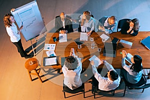 Top view of business conference, meeting. Young colleagues, co-workers, students during work process at office, indoors