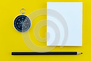 Top view business objects of white paper,pencil,and compass on paper work yellow background Flat lay composition