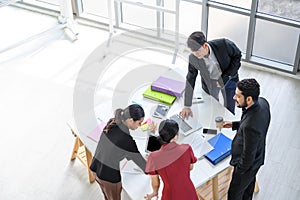 Top view of Business people group meeting in office. Aerial view with professional businesswomen and businessmen working in team