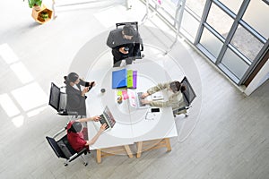 Top view of Business people group meeting in office. Aerial view with professional businesswomen and businessmen working in team