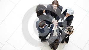 Top view of business people putting their hands together. Stack of hands.