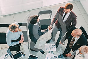 Top view. business people shaking hands in the meeting room.