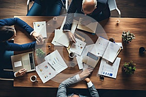 Top view of business people sitting at table and discussing something while working in office, Business meeting on a working table