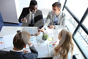 Top view of business people working together while spending time in the office.