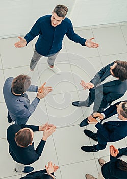 Top view. business team applauding their comrade.