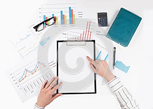 Top view of business womans hands point to a blank sheet on a tablet