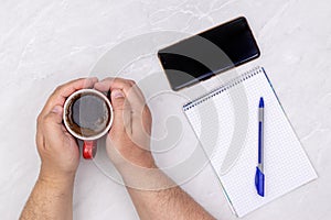 Top view business workspace hands cup of coffee empty copy space notepaper white background table