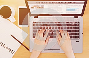 Top view  Businessman reading news on laptop at office desk