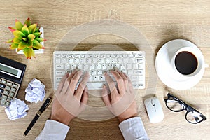 Top view of businessman working on laptop, he sitting at his working work space with cup coffee