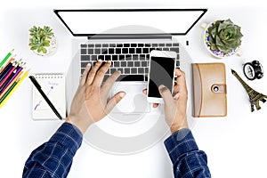 Top view businessman working with modern devices and smartphone, Man hand on laptop keyboard with blank screen monitor Man hand on