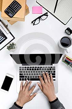 Top view businessman working with modern workplace with laptop on white table, Man hand on laptop keyboard with blank screen