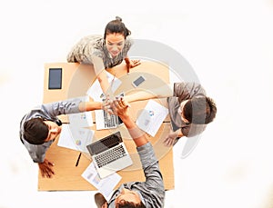 Top view businessmen and businesswoman standing and high five hands over table in meeting, copy space on isolated white background